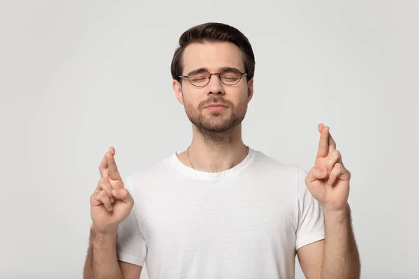 Superstitious worried millennial man in eyeglasses wishing good luck. — Zdjęcie stockowe