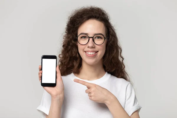 Happy smiling pretty young girl in eyeglasses demonstrating mobile screen. — 스톡 사진