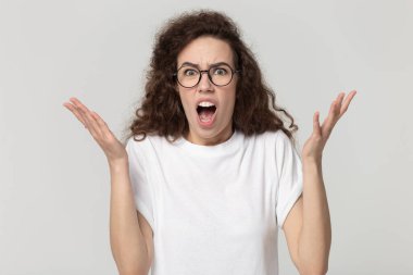 Millennial woman in eyeglasses feeling anger, annoyed by bad news.