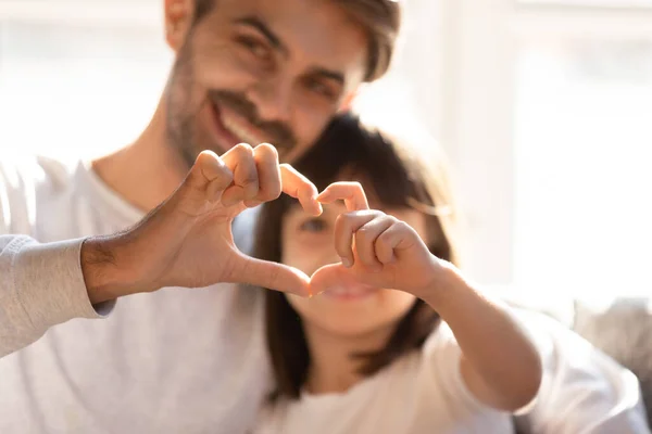 Happy young dad and little daughter make heart hand gesture — Stock Photo, Image