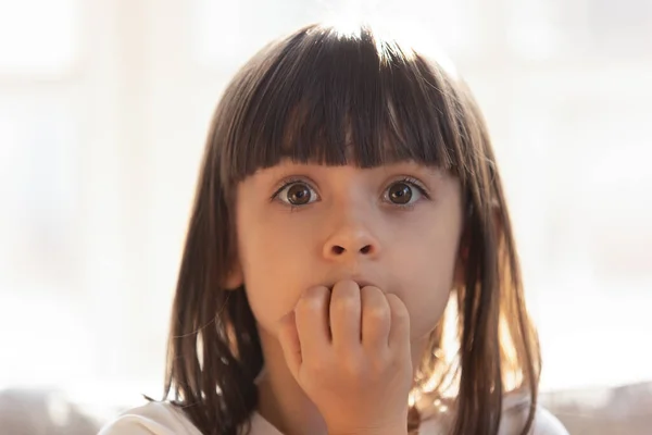 Scared little girl bite nails feeling terrified — Stock Photo, Image