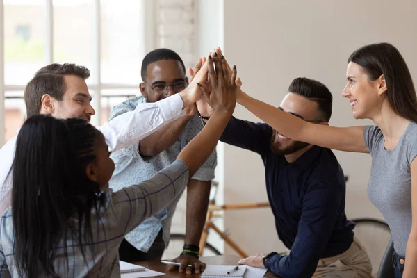 Excited multinational employees celebrating team victory giving high five — Stock Photo, Image