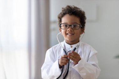 Head shot portrait funny African American little boy playing doctor