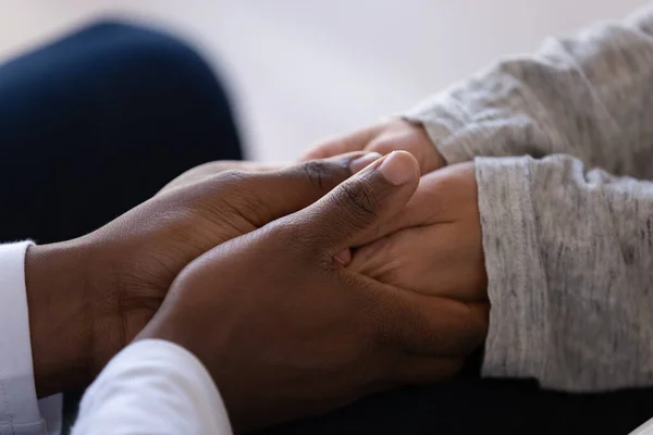 Close up African American man comforting woman, holding hands — Stock Photo, Image