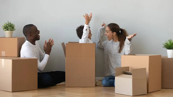Familia afroamericana feliz jugando con cajas en nuevo apartamento — Foto de Stock