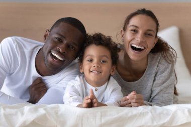 Head shot portrait happy African American family with little son