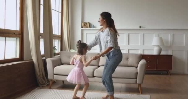 Overjoyed little child dancing twisting with mother. — Stockvideo