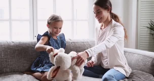 Playful mommy babysitter and kid daughter playing stuffed toys — Stockvideo