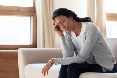 Upset african American woman feel lonely at home