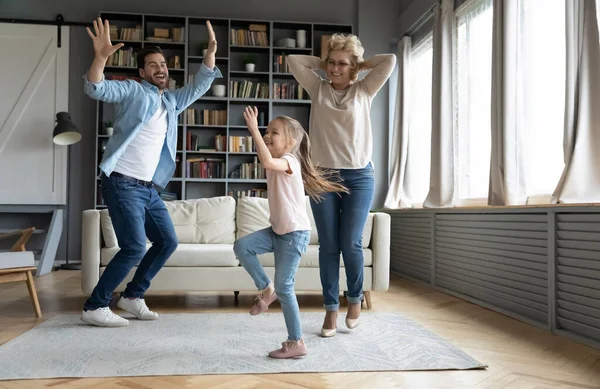 Overjoyed three family generations dancing at home — Stock fotografie