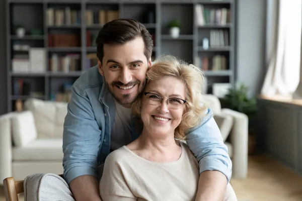 Portrait of grateful adult son hugging senior mother — Zdjęcie stockowe