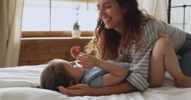 Jonge moeder spelen gluren een boo spel met kleuter dochter. — Stockvideo