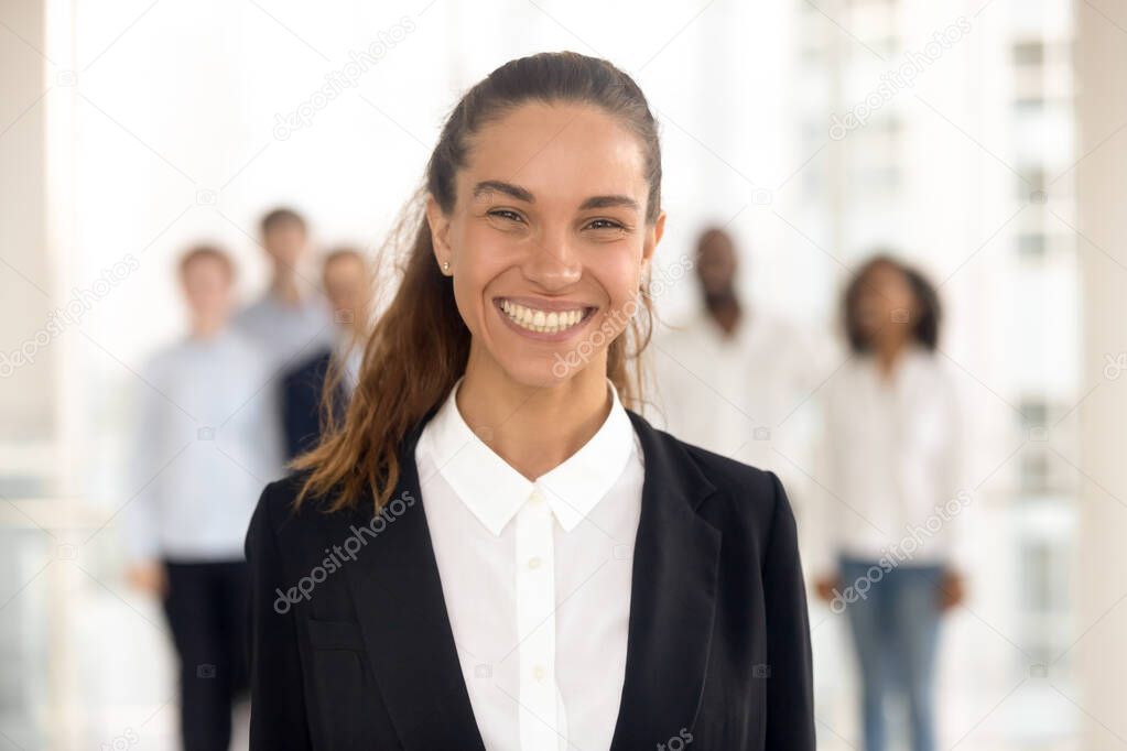 Close up portrait smiling mixed race businesswoman in office.