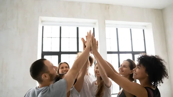 Group of sporty multiethnic people giving high five showing unity — Stock Photo, Image