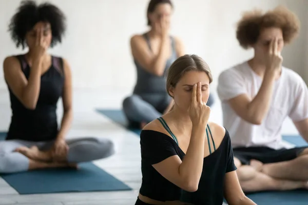 Group of multiethnic people doing yoga practice Alternate Nostril Breathing — Stock Photo, Image