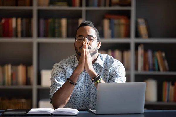 Frustrated millennial african american guy praying god with folded hands. — Stock Photo, Image
