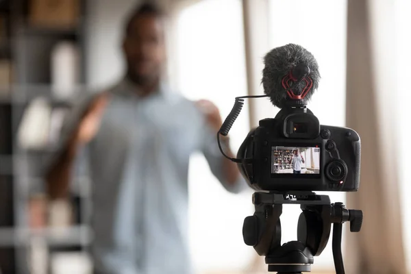 Close up focus on digital camera, showing mixed race man. — Stock Photo, Image