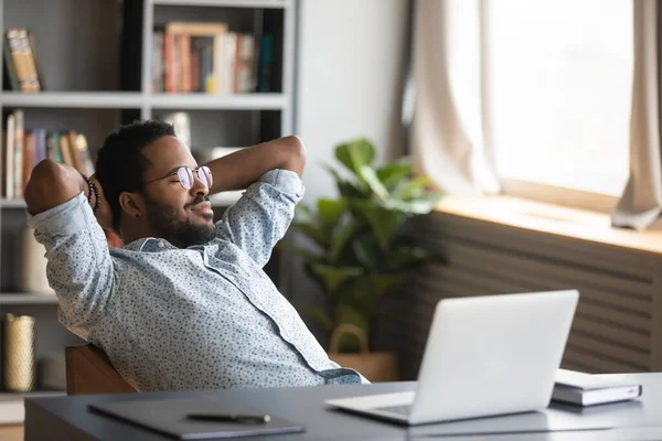 African american freelance man in glasses chilling on cozy chair. — Stok fotoğraf