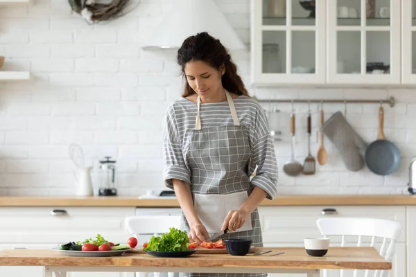 Millennial female preparing healthy lunch at home kitchen — Stok fotoğraf
