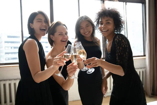 Portrait happy elegant diverse girls clinking champagne glasses — Stockfoto