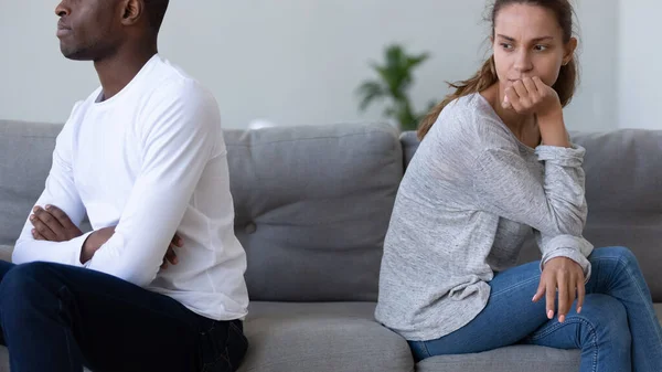 Upset woman feeling guilty after quarrel with African American man — Stock Photo, Image