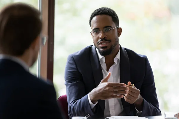 Biracial male employee talk with colleague in office — Stock Photo, Image