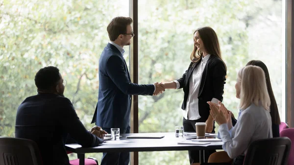 Confident businessman shake hand greeting female colleague — Stock Photo, Image