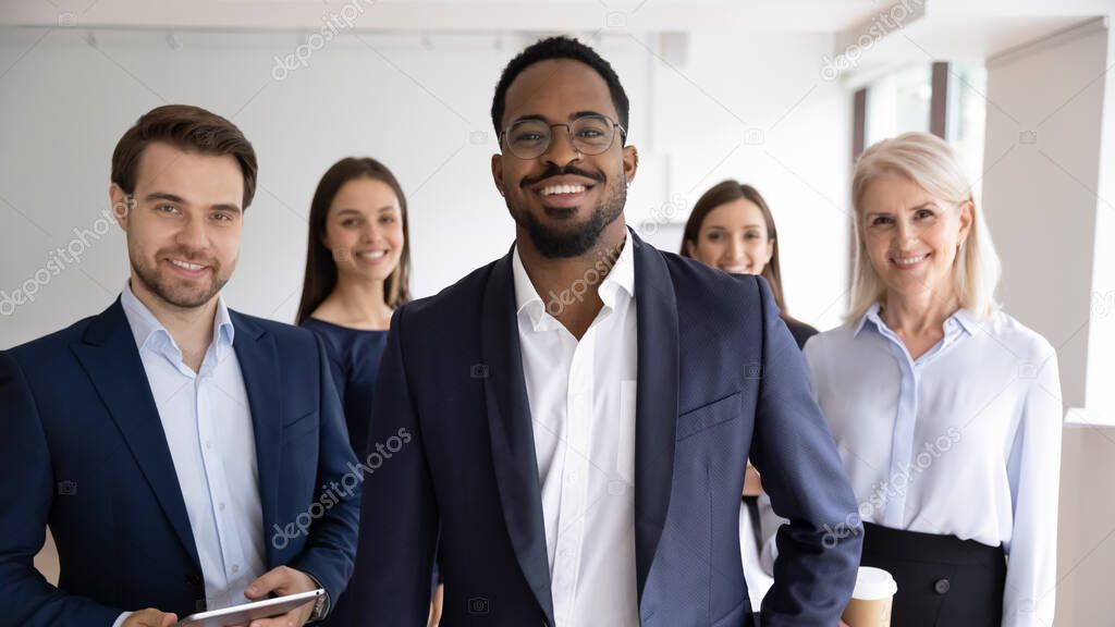 Portrait of diverse colleagues posing together in office