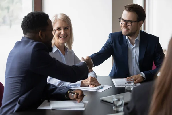 Smiling male partners handshake greeting at office meeting — Stock Photo, Image