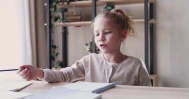 Funny school child girl studying alone feeling bored or tired
