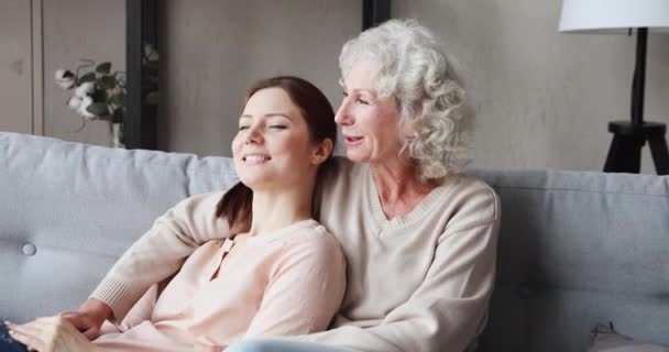 Happy serene grandmother and grown granddaughter bonding at home — ストック動画