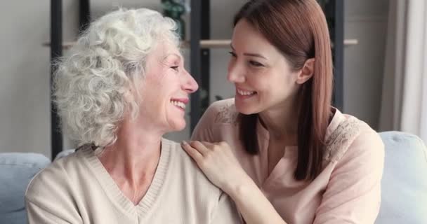 Relaxed happy young daughter embracing old mother and laughing, portrait — Stok video