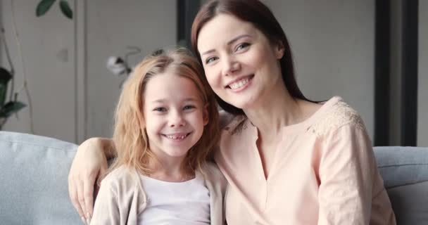 Affectionate young mother and small daughter bonding looking at camera — 图库视频影像