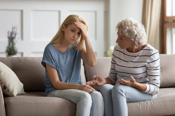 Authoritative mature mom lecturing frustrated grownup daughter — Stock Photo, Image