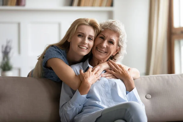 Portrait of happy senior mom and adult daughter hugging — Stock Photo, Image