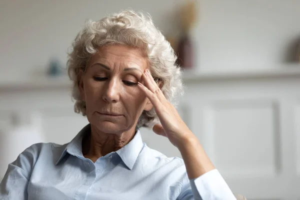 Unhappy mature woman lost in thoughts at home — Stock Photo, Image