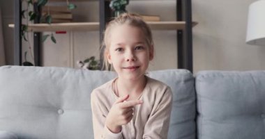 Funny child girl blogger talking to camera shooting vlog