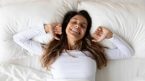 Happy girl stretching in bed waking up in morning — Stok Foto