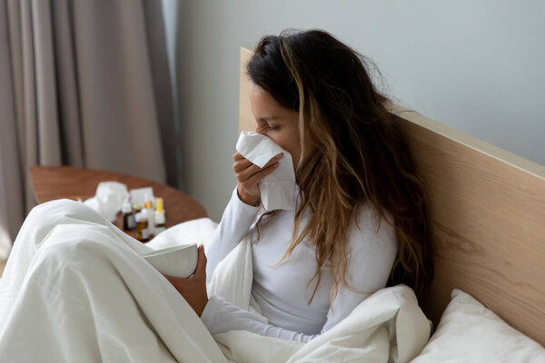 Sick young woman feel ill resting at home