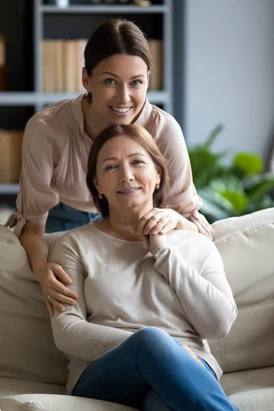 Portrait happy grownup daughter hugging pleasant mother. — Stock Photo, Image