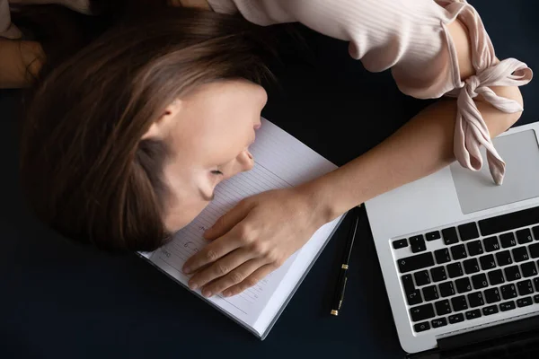 Top above view restless young woman freelancer sleeping on table. — Stock Photo, Image