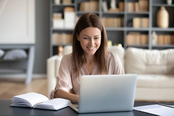 Молодая счастливая женщина работает дома за компьютером . — стоковое фото