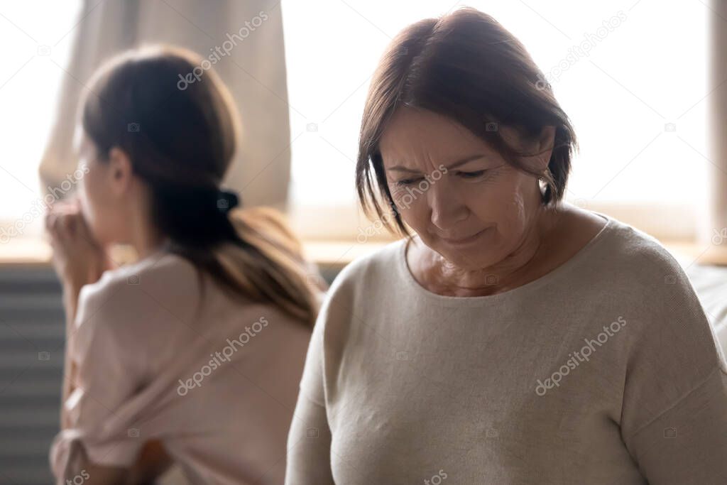 Unhappy senior mature mother feeling despair after quarrel.
