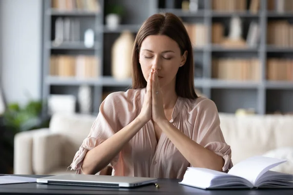 Hopeful employee sitting at table with folded hands. — Stock Photo, Image