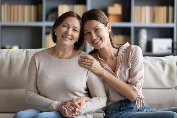 Affectionate two generations family looking at camera, posing for photo. — Stock Photo, Image