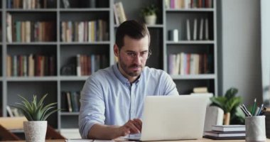 Excited business man checking email receiving great news on laptop