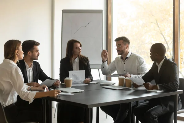 Mixed race young business employees team listening to leader. — Stock Photo, Image