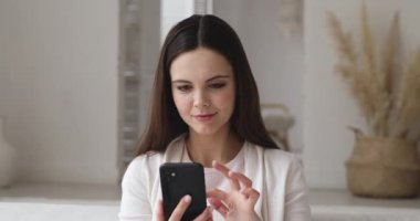 Excited girl holding smartphone reading good news in social media