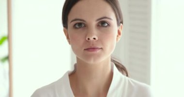 Confident smiling young 20s woman wear gown looking at camera