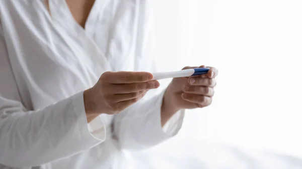 Close up quick plastic pregnancy test in female hands. — Stock Photo, Image